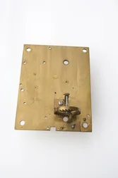 The inside of the back plate of a table clock